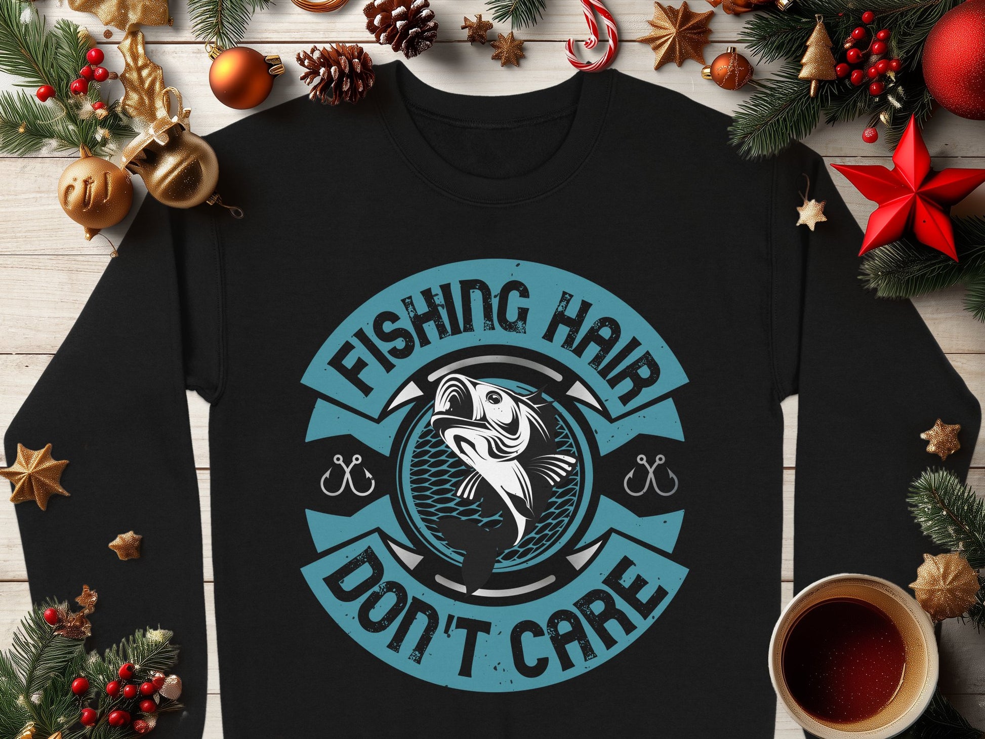 Garment Graphics black fishing sweatshirt features a playful Fishing Hair Dont Care print with a charming fish illustration, resting on a wooden surface among festive Christmas decorations and a steaming cup of beverage, ideal for fishing enthusiasts this holiday season.