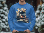 Dressed in a Garment Graphics sweatshirt featuring Keep on Trucking and a bold truck design, an individual stands against snow-covered trees, embodying the spirit of the open road in winter.