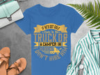 Garment Graphics offers a womens blue T-shirt with a quirky design that reads: If hes got golf clubs in his truck or a camper in his driveway, I dont hire him. Ideal for fans of funny golf graphic tees, its photographed among accessories on a gray surface.