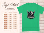 Size chart for Garment Graphics Freebird Eagle T-Shirt in green heavy cotton (Gildan 5000), featuring a striking bird with spread wings. Available in sizes S to 5XL, with dimensions in inches. Displayed elegantly on a wooden background.