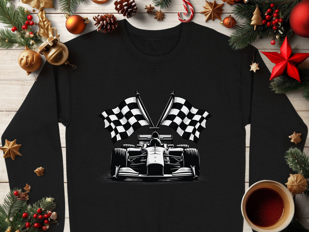 Garment Graphics offers a black shirt showcasing a striking white racing car illustration with crossed checkered flags, surrounded by festive decor like pine branches, pinecones, ornaments, and a coffee cup on wood.