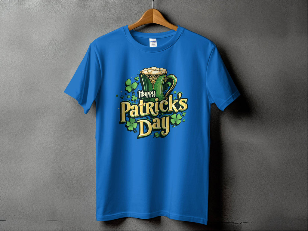 A blue statement T-shirt by Garment Graphics hangs on a wooden hanger against a gray background, featuring a green beer mug, shamrocks, and bold yellow and green text Happy Patricks Day, perfect for festive celebrations.