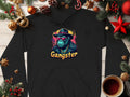 Adopt a smokey cool style with Garment Graphics black hoodie, featuring a vibrant gangster gorilla graphic. Made from medium-heavy fabric, its ideal for chilly days amidst holiday décor like pine cones, ornaments, and a steaming coffee cup on a wooden table.