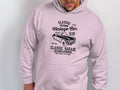 Someone wears a light-colored hoodie by Garment Graphics featuring a London City Vintage Car design. Its perfect for car lovers and reads, Classic Vintage Car Club, London City, Classic Garage, Old School Automotive, High Performance since 1982, blending style with classic fit.