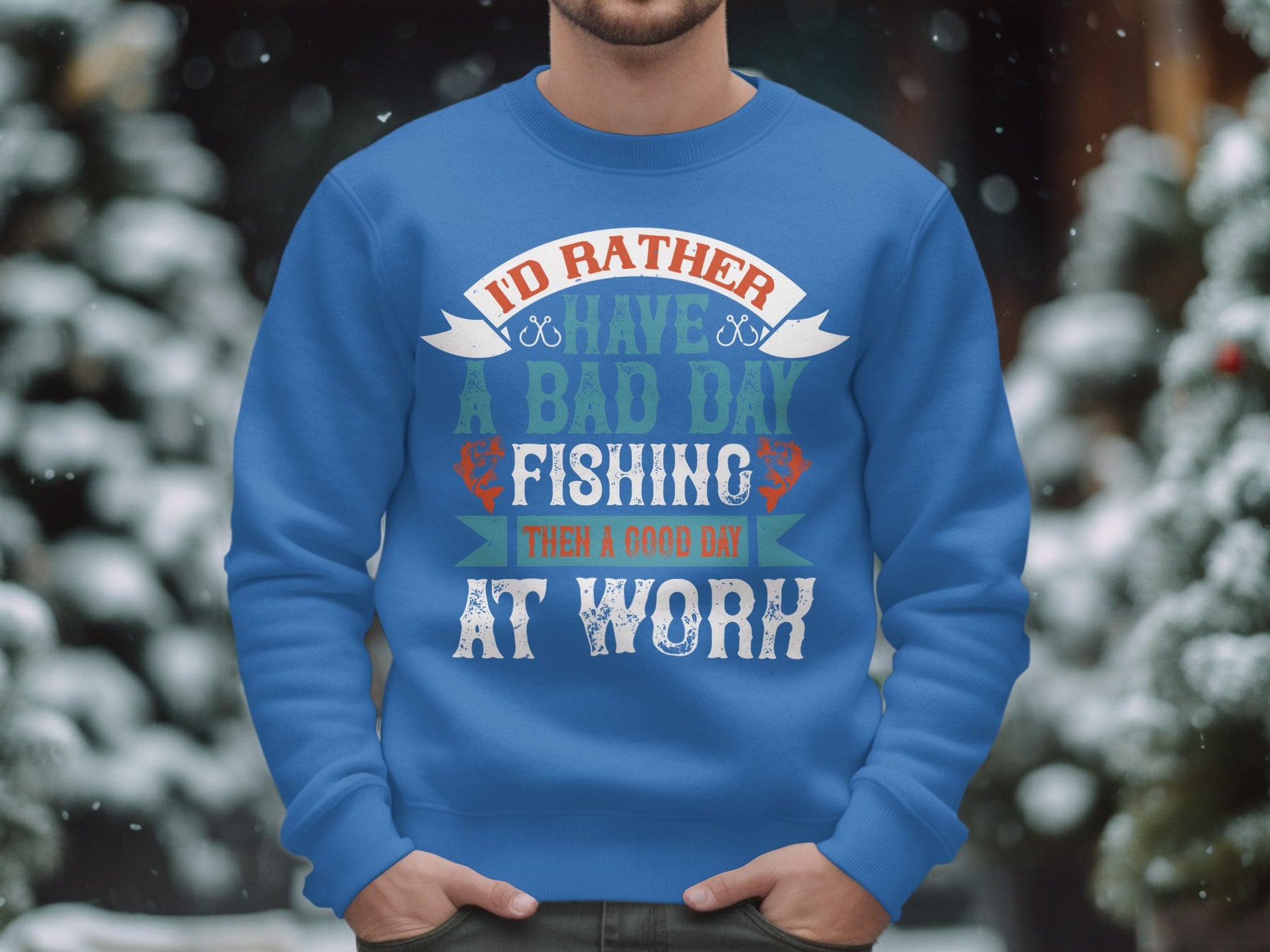 Wearing Garment Graphics blue fishing sweatshirt with Id Rather Have a Bad Day Fishing Than a Good Day at Work, against a backdrop of blurred snowy trees and holiday lights, makes an ideal gift for fishing enthusiasts.