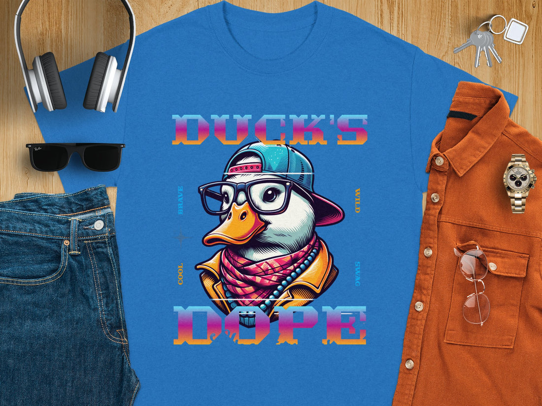 Someone sports a white Garment Graphics T-shirt with a stylized duck in glasses, cap, and scarf. The phrase Ducks Dope frames the image against grass-green backdrop, embodying unique style.