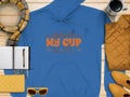 A blue Youre my cup of tea hoodie by Garment Graphics is displayed with essentials like a plaid scarf, coffee mug, quilted jacket, yellow clutch, notebook, pen, and sunglasses.