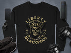 Garment Graphics offers a stylish black sweatshirt showcasing a skull with goggles and a helmet, encircled by Liberty Motorcycles Specialist Blackpool 2023. Essentials like a phone, smartwatch, shoes, dumbbells, and portable speaker complete the perfect Blackpool 2023 collection.