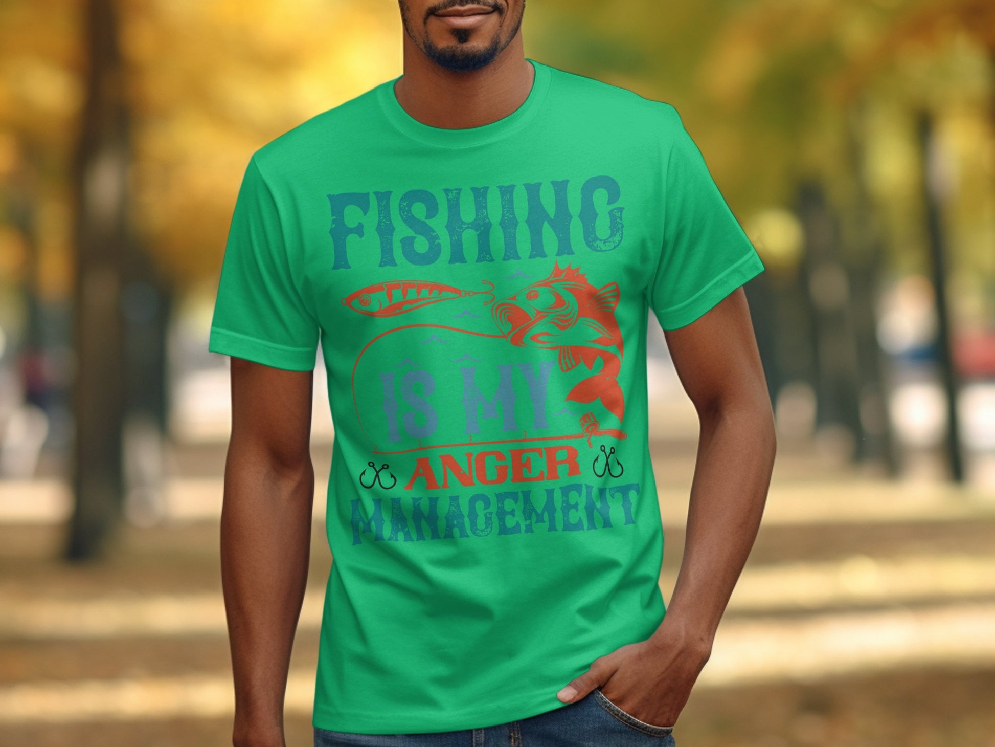 A fishing enthusiast sports a Garment Graphics green t-shirt emblazoned with Fishing Is My Anger Management and decorated with fish hooks and a fish, set against blurry trees in the background.