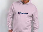 Against a light backdrop, a person dons a white hoodie featuring the iconic Scania logo in blue. This distinctive piece from Garment Graphics captures modern style with its understated yet impactful branding.
