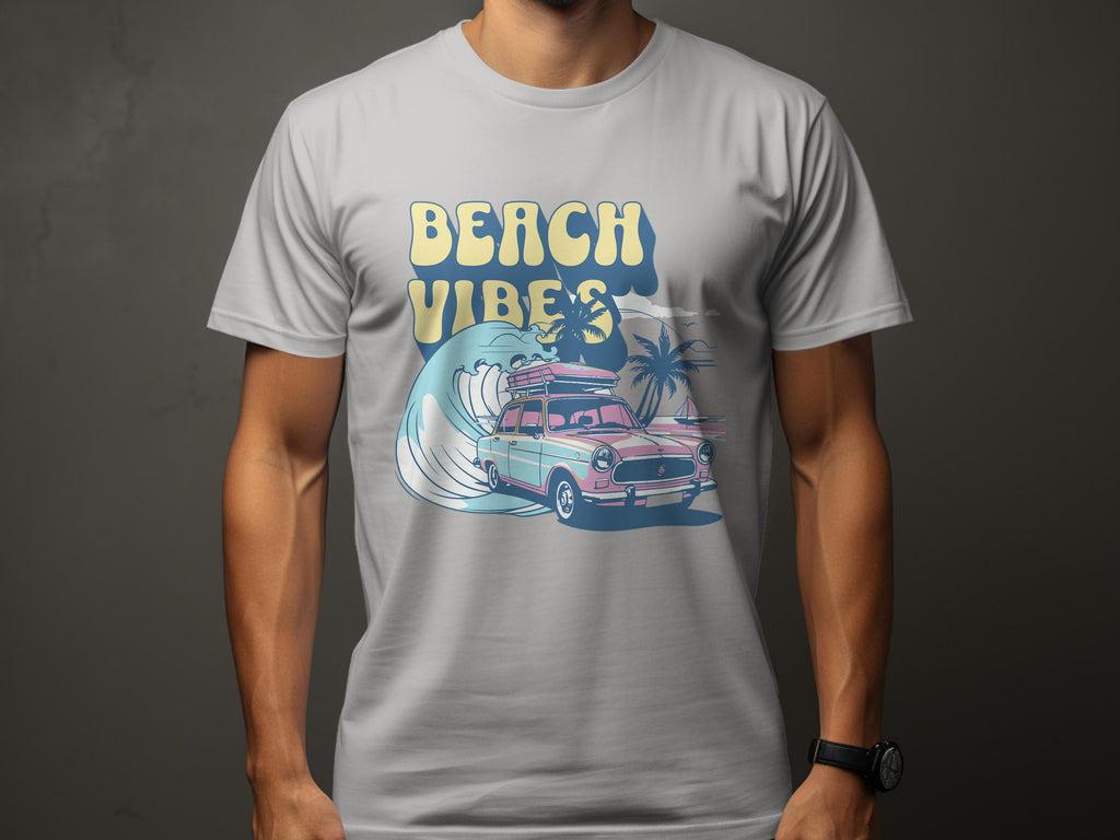A person dons a Garment Graphics T-shirt featuring a classic pink vintage car with a surfboard atop, cruising on a wave encircled by palm trees, and the bold text Beach Vibes completing the look.