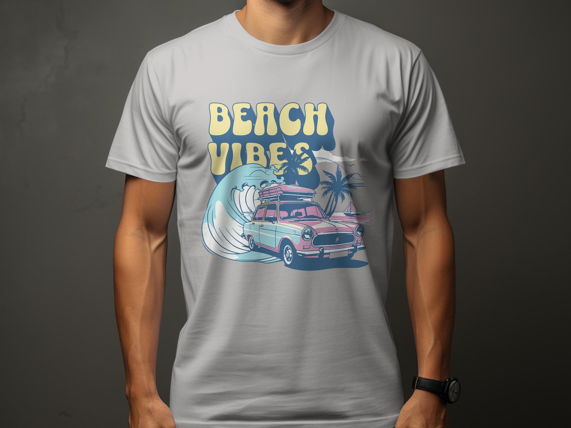 A person dons a Garment Graphics T-shirt featuring a classic pink vintage car with a surfboard atop, cruising on a wave encircled by palm trees, and the bold text Beach Vibes completing the look.
