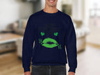 A person is wearing a Garment Graphics dark blue sweatshirt featuring Happy St. Patricks Day in green letters, two shamrocks, and a festive green clover kiss. The background is a blurred indoor setting.