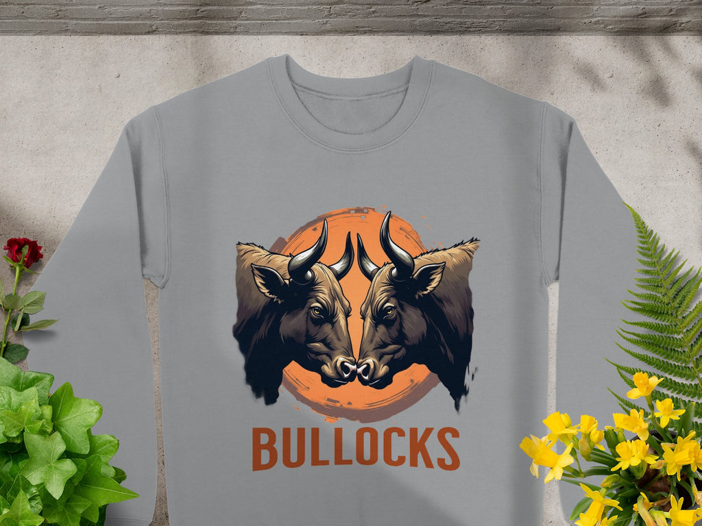 Garment Graphics presents this bold gray sweatshirt with a striking bullocks print, featuring two bulls facing each other against a sunset backdrop, surrounded by vibrant plants and flowers. The loose fit adds flair to any wardrobe.