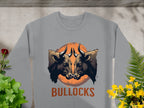 Garment Graphics presents this bold gray sweatshirt with a striking bullocks print, featuring two bulls facing each other against a sunset backdrop, surrounded by vibrant plants and flowers. The loose fit adds flair to any wardrobe.