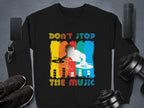 Garment Graphics offers a black DJ sweatshirt featuring a vibrant graphic of a DJ and Dont Stop the Music text. Ideal for music lovers, its available in unisex sizes. Nearby items are a smartphone, smartwatch, speaker, dumbbells, and athletic shoes.
