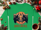 This green unisex long-sleeve shirt by Garment Graphics features two forward-facing bulls on an orange circular background, with BULLOCKS printed below amidst pine branches, ornaments, and a coffee cup on wood.