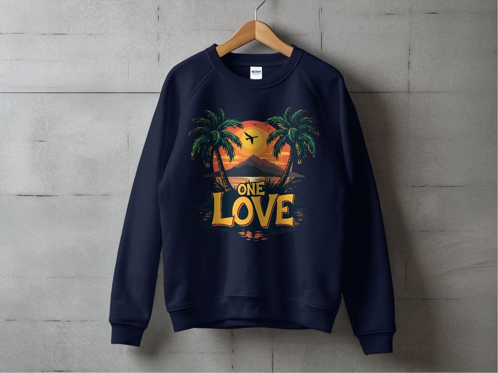 A navy Garment Graphics sweatshirt on a wooden hanger displays a sunset with palm trees and bird silhouette, highlighted by bold One Love text against a concrete background. Part of the One Love Sweatshirts line, it offers unisex sizing for versatile style.