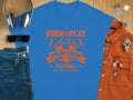 Garment Graphics presents a blue football T-shirt with bold orange Born to Play, One Goal - One Dream lettering. Pair it stylishly with sunglasses, jeans, headphones, an orange button-up shirt, keys, and a watch for the Young Squad ready to kick, score, and celebrate.