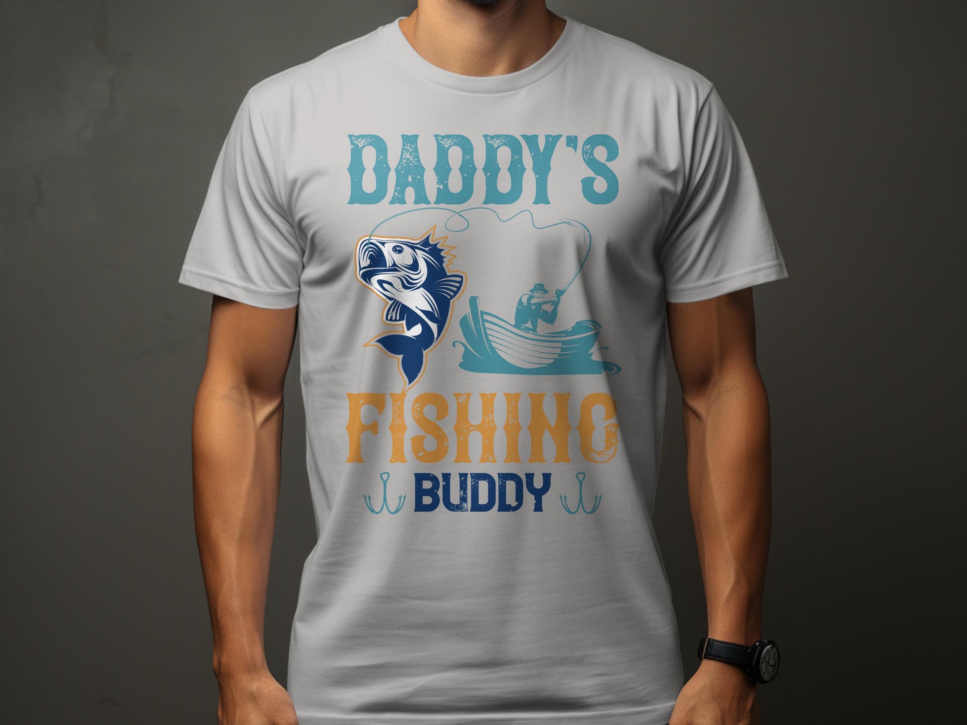 A person is wearing a Garment Graphics white t-shirt with a lively design featuring Daddys Fishing Buddy in blue and orange, showcasing a fish leaping near an angler—ideal for fishing enthusiasts.