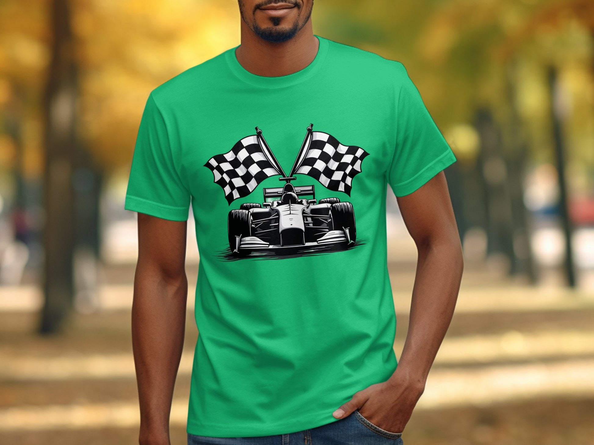 A person in a Garment Graphics green graphic T-shirt with a race car and two checkered flags stands against blurred trees with autumn foliage, embodying motorsports vibrant essence.