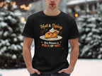 In a snowy setting, someone wears a black Garment Graphics t-shirt with the Hot & Spicy Pie Design, featuring a pie with whipped cream and the playful tagline, You Wanna a Piece of Me?.