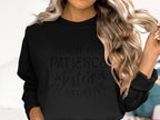 A person with long, wavy blonde hair is wearing a quirky unisex black sweatshirt from Garment Graphics, featuring the text I had my patience tested, Im negative, ideal for casual outings and ensuring a comfortable fit for everyone.