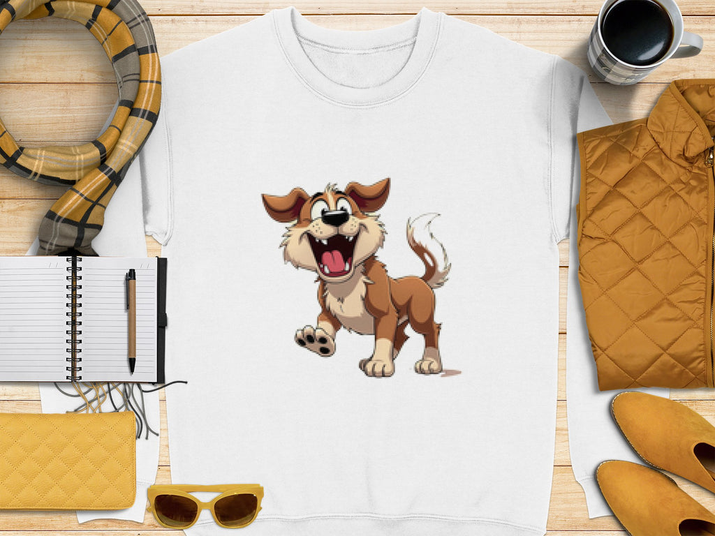 Garment Graphics white sweatshirt displays a cheerful dog illustration, ideal for dog enthusiasts. Presented on a wooden background with a plaid scarf, notebook, pen, quilted items, sunglasses, and a coffee cup.
