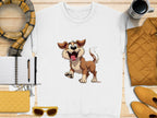 Garment Graphics white sweatshirt displays a cheerful dog illustration, ideal for dog enthusiasts. Presented on a wooden background with a plaid scarf, notebook, pen, quilted items, sunglasses, and a coffee cup.