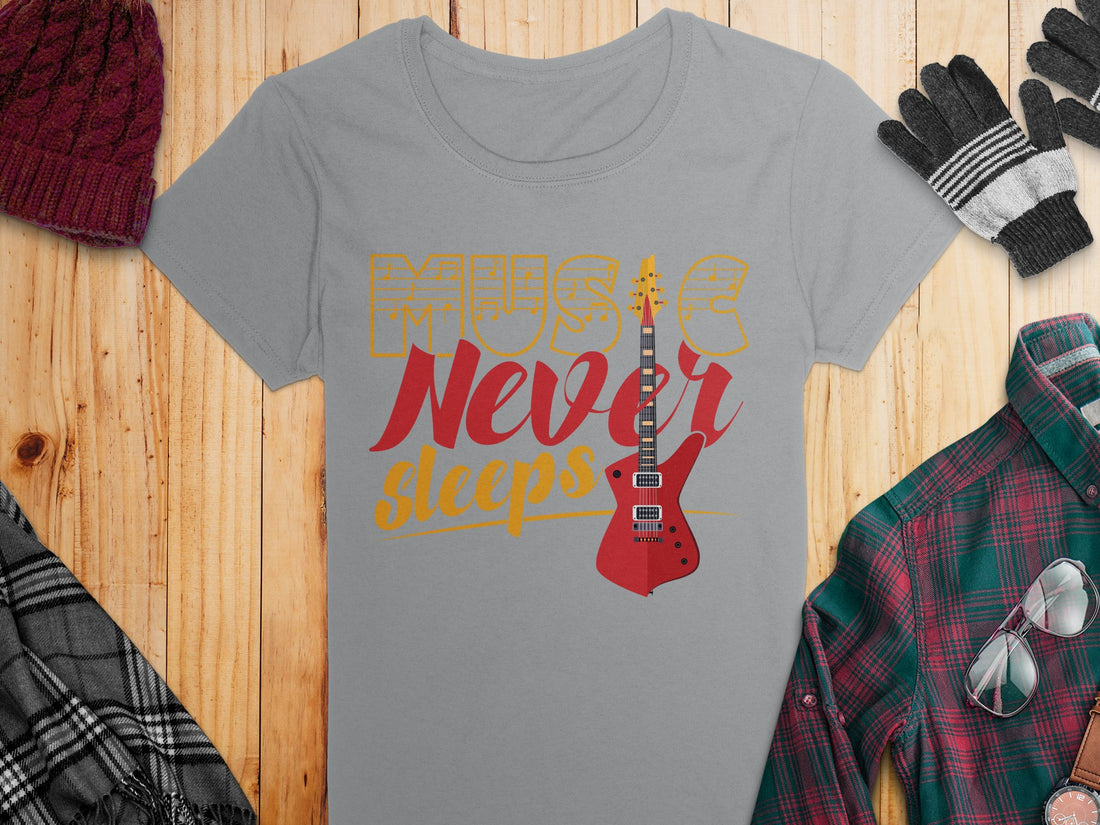 Garment Graphics presents a unique T-shirt with the inspiring Music Never Sleeps slogan and a bold red guitar print. Perfectly laid on a wooden surface, its surrounded by gifts and holiday decor—ideal for guitar T-shirt fans this season.