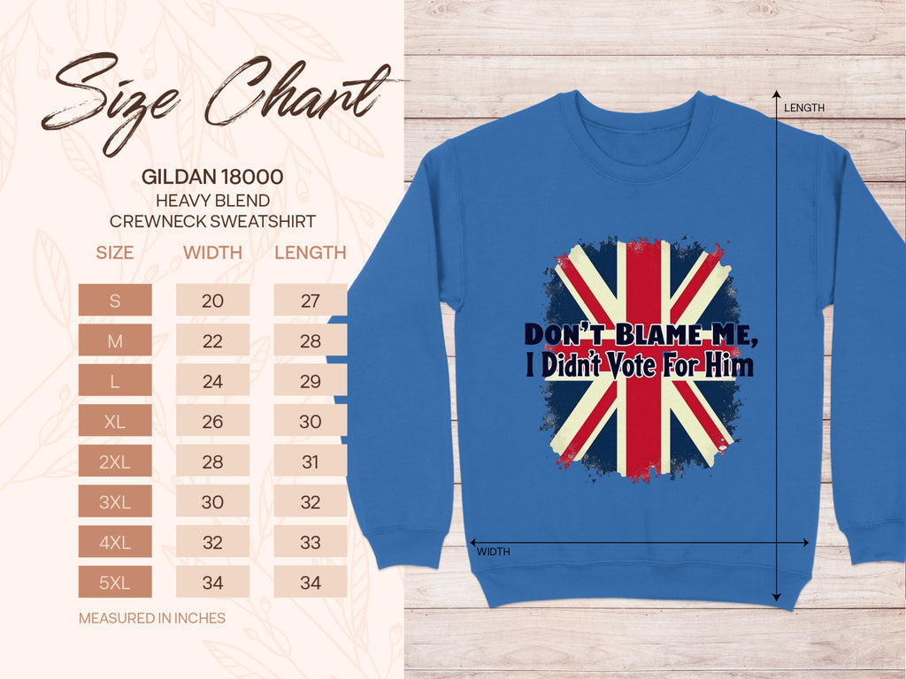 Garment Graphics offers a cozy blue crewneck sweatshirt featuring a striking red, white, and blue flag-inspired graphic with the phrase Dont Blame Me, I Didnt Vote For Him. The size chart on the left details dimensions for S to 5XL in inches.