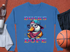 Garment Graphics blue sweatshirt showcases a vibrant duck graphic with glasses, hat, and scarf, surrounded by the phrases Ducks Dope and Cool, Street, Cute, Fresh. It offers unisex sizing and medium-heavy fabric comfort. Posed on orange with nearby basketball gear.