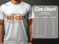 A person wears a Garment Graphics white graphic T-shirt with Youre My Cup of Tea in brown. To the right, a size chart lists the Gildan 5000 heavy 100% cotton T-shirt sizes (S to 5XL) with their width and length, marked by a diagonal line showing dimensions in inches.