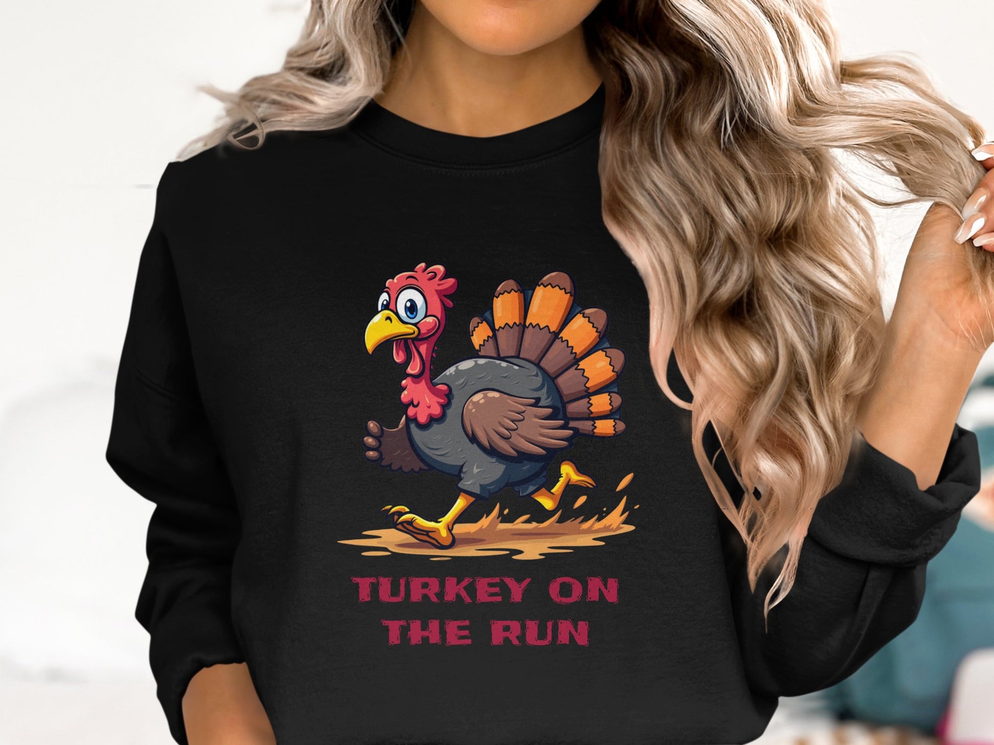 A person with long, wavy hair wears a black Garment Graphics unisex sweatshirt featuring a funny cartoon turkey on the run and the text TURKEY ON THE RUN.