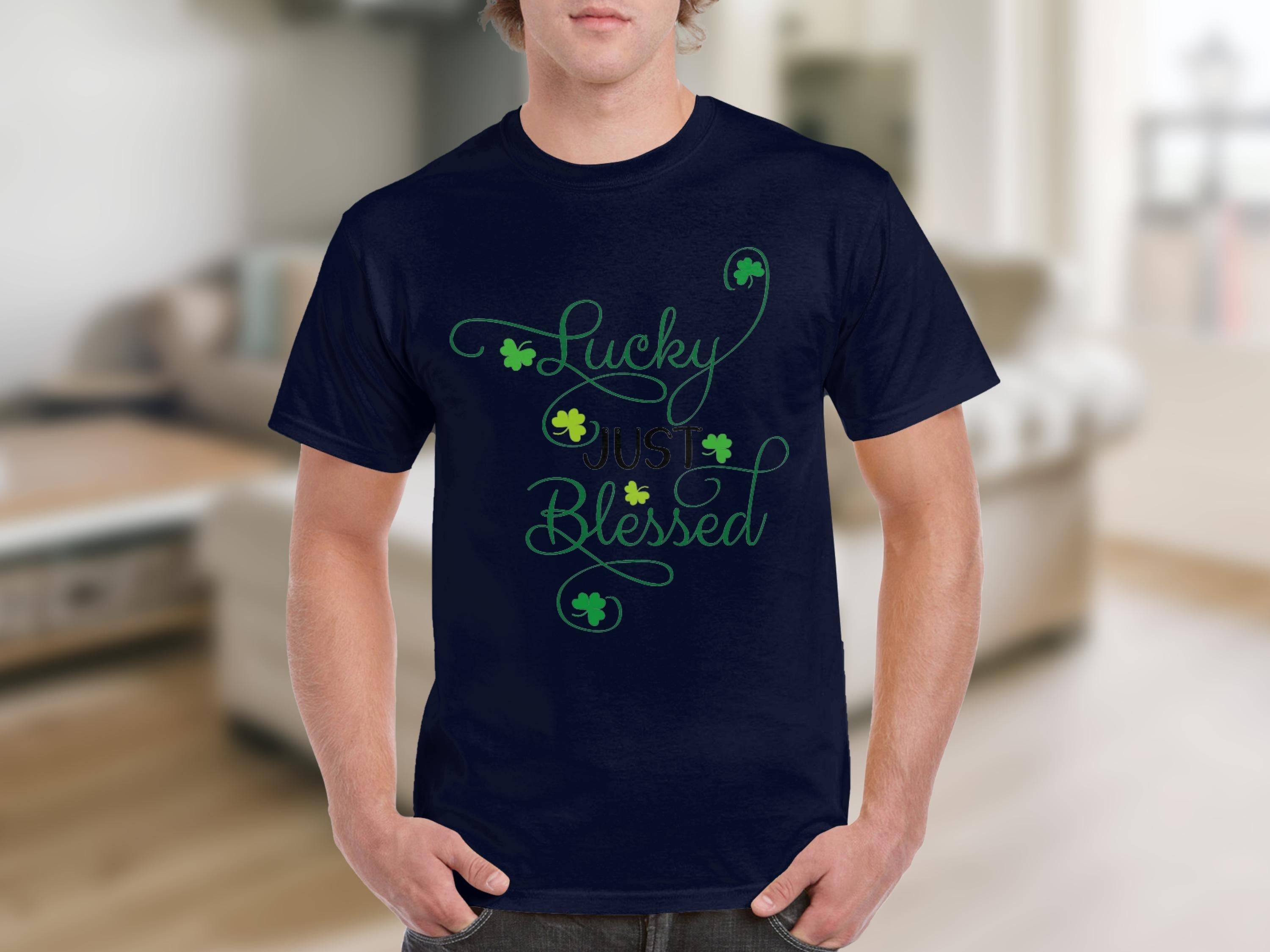 A person wears a classic fit navy blue graphic t-shirt from Royal Mail - 24 Tracked, featuring Lucky Just Blessed in green with shamrocks. The blurred indoor background accentuates the designs charm.