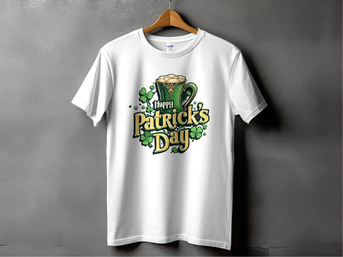 Wearing a colorful Happy Patricks Day T-shirt from Garment Graphics, adorned with shamrocks and a frothy beer mug, a person enjoys the outdoor festivities on lush grass with sandy terrain in the background, making a bold statement.