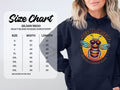 A person in a black Garment Graphics Bee Yourself Hoodie featuring a colorful bee and the text Bee Yourself, Everyone Else is Taken. Beside them is a size chart for the Gildan 18500 sweatshirt with sizes small to 5XL, showing width and length in inches.