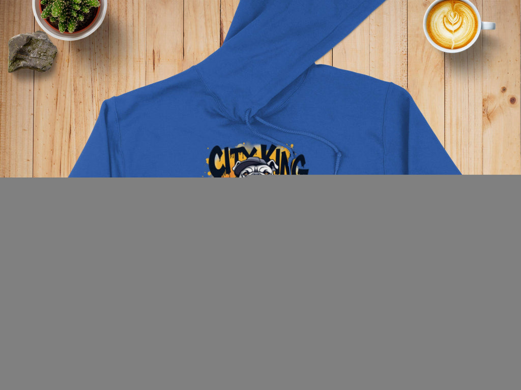 The blue Classic Fit Graphic Bulldog Design Hoodie by Garment Graphics showcases a bulldog in a spiked collar on flames with CITY KING text. Styled on wood alongside a denim jacket, latte, and potted plant, its an ideal addition to your casual wardrobe.