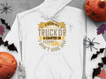 Garment Graphics presents a white hoodie with the humorous slogan: If hes got bull calves in his truck or a camper in his driveway I dont hire him, alongside a truck hauling a camper, adorned with Halloween-themed elements like pumpkins, bats, and skeletons—ideal for quirky gifts!.