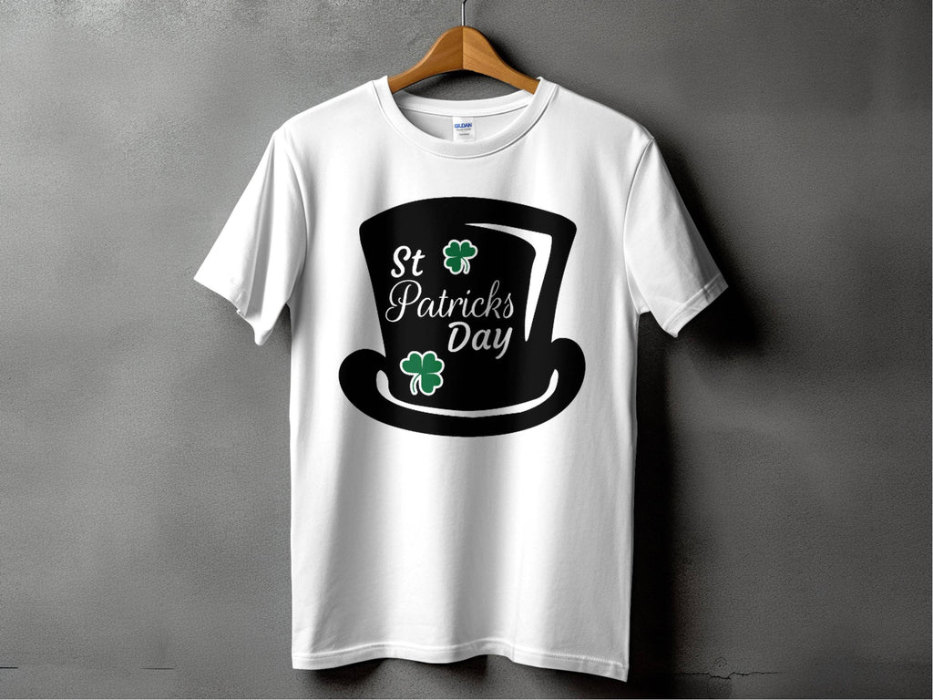 Garment Graphics white T-shirt features St. Patricks Day text, a black top hat, and two green shamrocks reminding of a four-leaf clover, against a gray background—ideal for festivities.