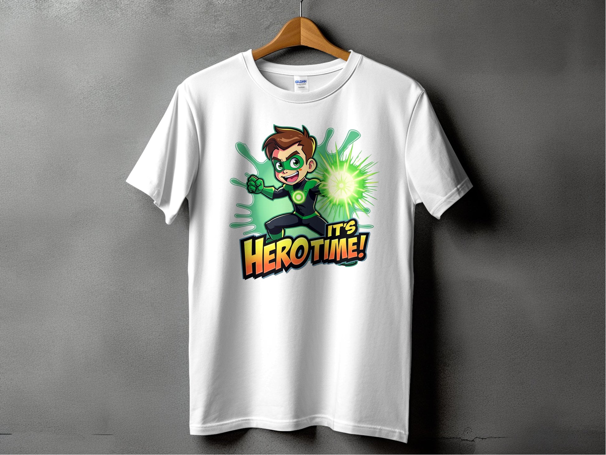 The Garment Graphics superhero graphic tee, featured on a hanger, showcases a cartoon character with green gloves and a glowing orb. Bold text states Its Hero Time! Ideal for family sizing, it adds vibrant comic charm to any wardrobe.