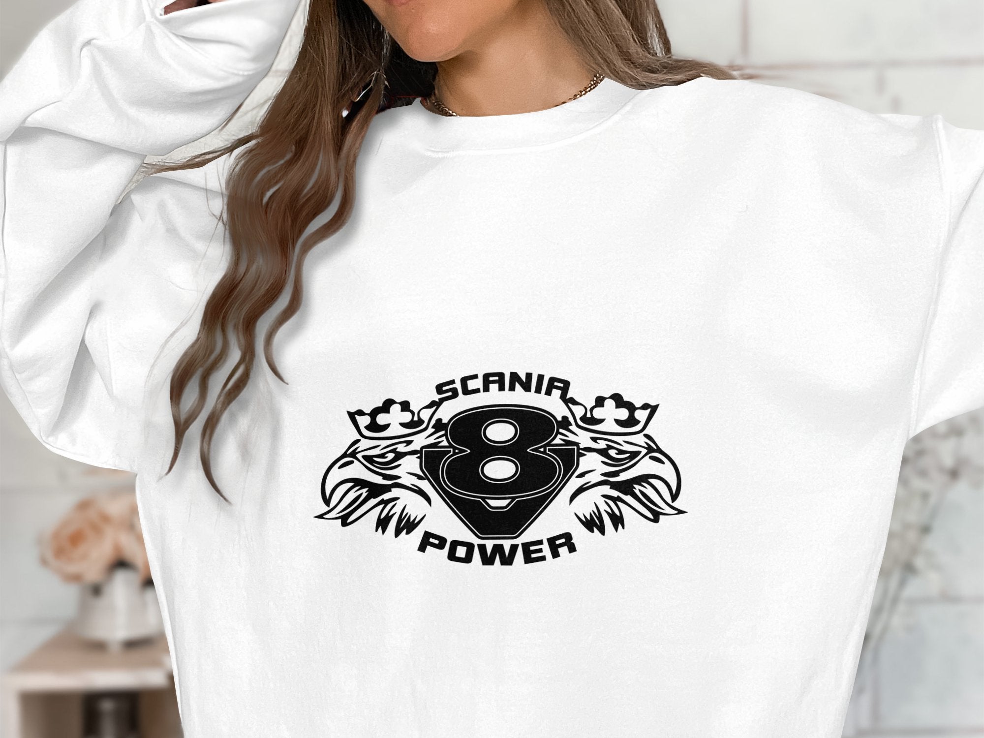 This stylish Garment Graphics white sweatshirt features a bold black graphic with two stylized eagle heads, the text SCANIA POWER, and the number 8, offering a cool Scania Power V8 design for any wardrobe.