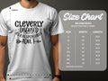 A person is wearing a white Cleverly Disguised as a Responsible Adult T-shirt by Garment Graphics, ideal for casual outings. The classic fit Gildan 5000 heavy cotton tee comes with a size chart ranging from S to 5XL, displaying width and length in inches.