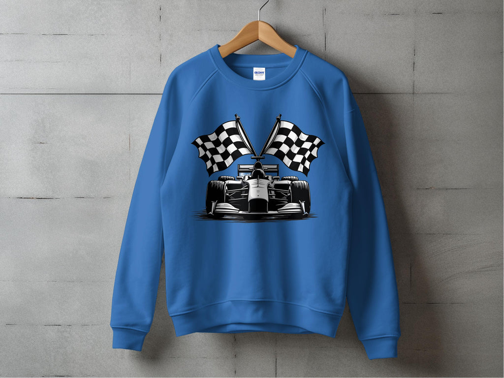 On a hanger against a concrete wall, the Garment Graphics blue racing car sweatshirt showcases a bold race car graphic with two crossed checkered flags, enhancing its distinctive checkered flag print appeal.