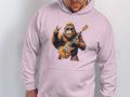 A person models a light pink music lovers hoodie from Garment Graphics, featuring a cool gorilla wearing sunglasses, holding an electric guitar and flashing a peace sign.