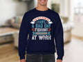 A person wearing a navy sweatshirt from Garment Graphics Fishing Passion Apparel line shows off the message: I’d rather have a bad day fishing than a good day at work. This unisex fishing sweatshirt showcases decorative typography in multiple colors.