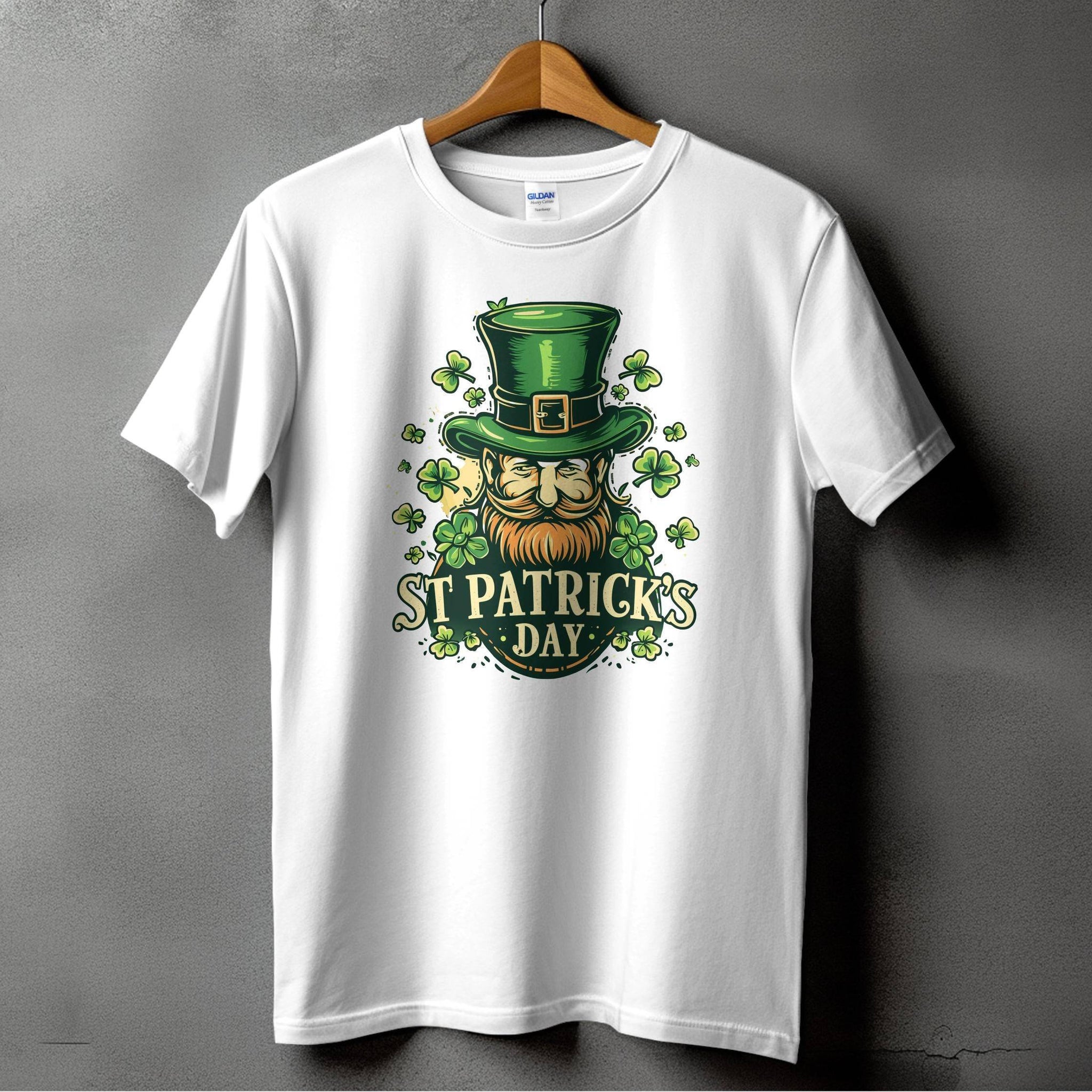 A white t-shirt by Garment Graphics hangs on a wooden hanger against a gray background, featuring an Irish pride print: a ginger-bearded man with a green top hat and shamrock designs, with the text St. Patricks Day, capturing the festive spirit of St. Patricks Day T-Shirts.