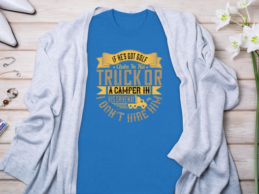 A Garment Graphics blue t-shirt with the funny graphic “If he’s got golf clubs in his truck or a camper in his driveway, don’t hire him,” styled on a gray cardigan surrounded by white flowers, jewelry, and shoes—ideal for those who appreciate camping humor.