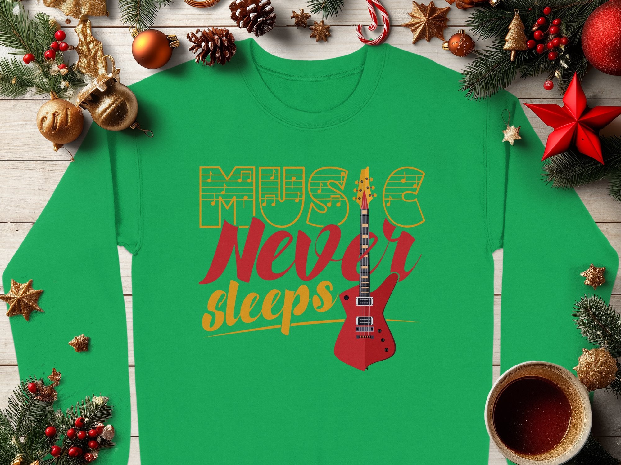 Garment Graphics presents a vibrant green guitar-themed sweatshirt adorned with Music Never Sleeps in bold red and yellow. Ideal for music lovers, it features an eye-catching electric guitar amid festive Christmas decor, ornaments, pine branches, and a steaming coffee cup on a wooden table.