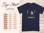Size chart for Garment Graphics heavy cotton tee on wooden background. Displayed is a navy 100% cotton shirt with Freebird eagle graphic. Sizes S-5XL listed with width and length measurements in inches.